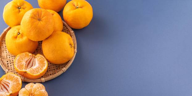 Beautiful and delicous tangerine isolated on airy blue backgroun