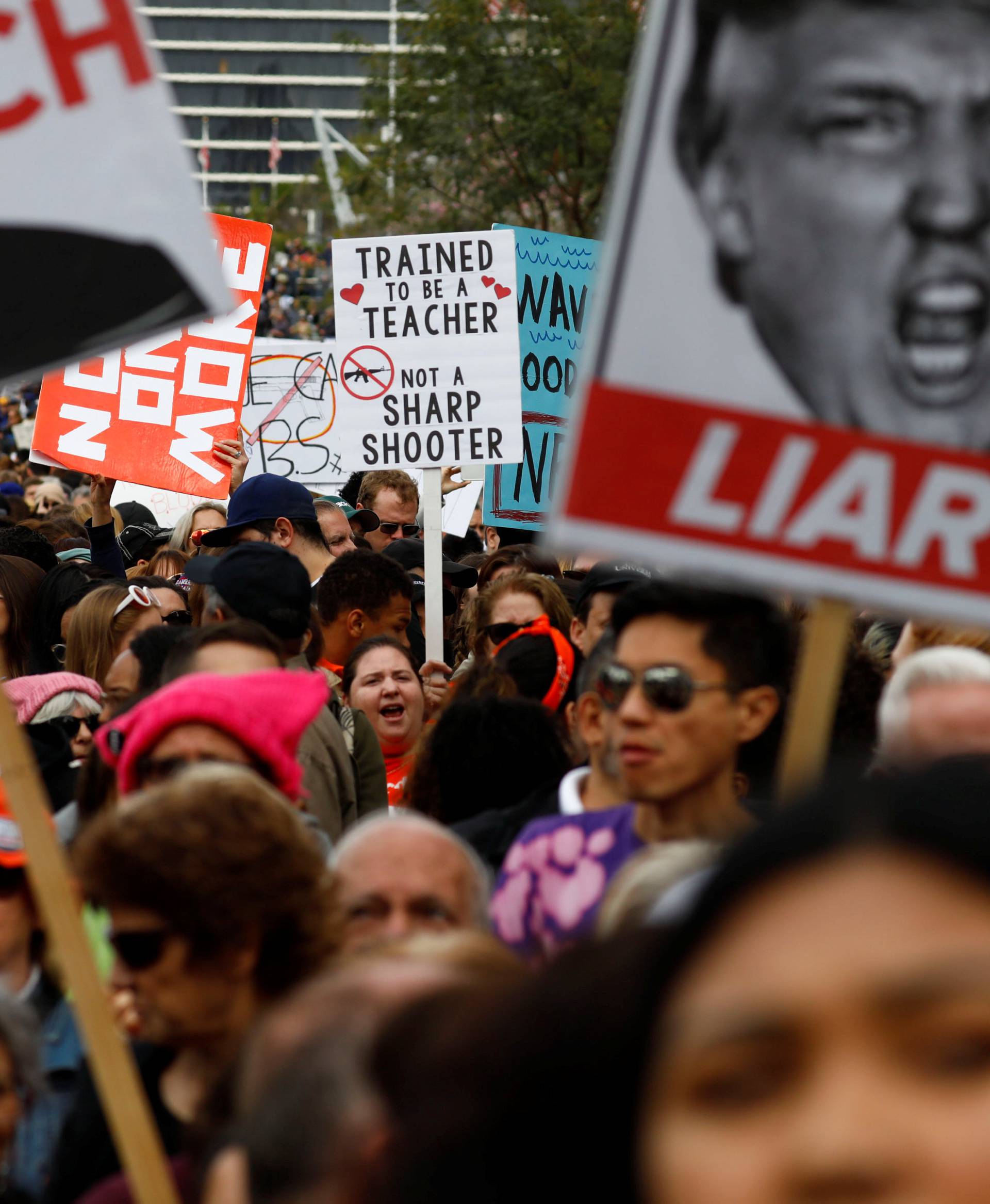 An attendee holds a sign in support of teachers during "March for Our Lives", an organized demonstration to end gun violence, in downtown Los Angeles