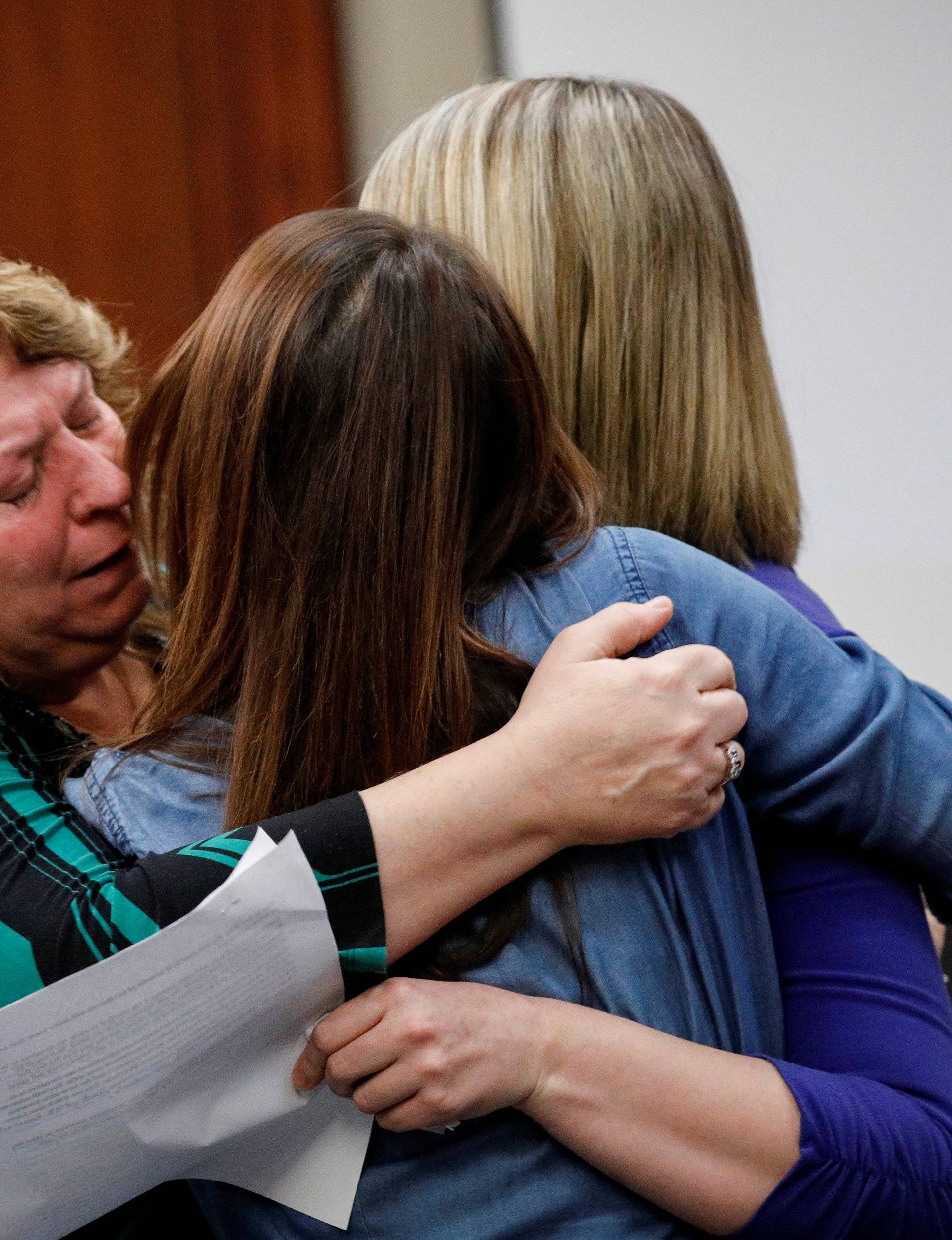 Victim Krista Wakeman is comforted by her mother and a friend after speaking at the sentencing hearing for Larry Nassar, a former team USA Gymnastics doctor who pleaded guilty in November 2017 to sexual assault charges, in Lansing, Michigan