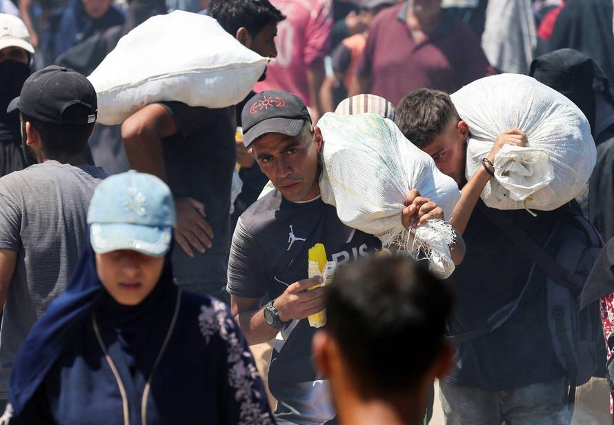 Palestinians receive aid supplies from the U.S.-backed Gaza Humanitarian Foundation, near Rafah