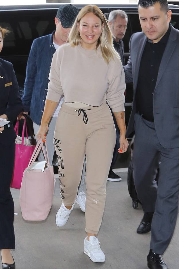 Sia goes makeup free as she sports a nude colored Kenzo outfit at LAX