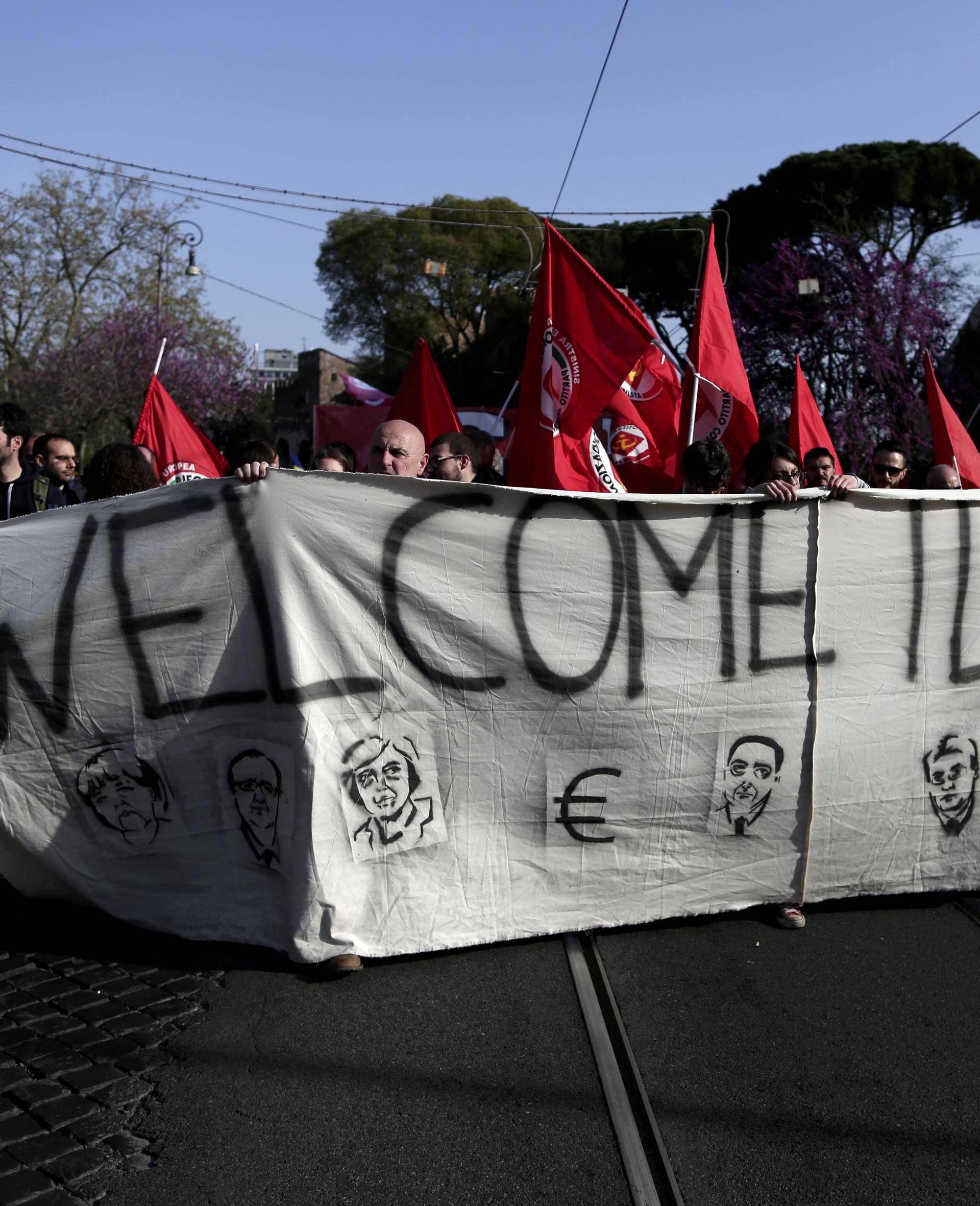 Protesters hold a banner during an anti-EU demonstration as European Union leaders meet on the 60th anniversary of the Treaty of Rome