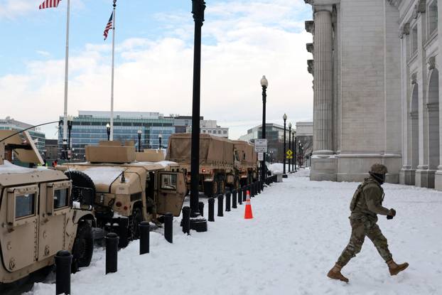 Commuters make their way though snow and ice in the aftermath of a winter storm in Washington