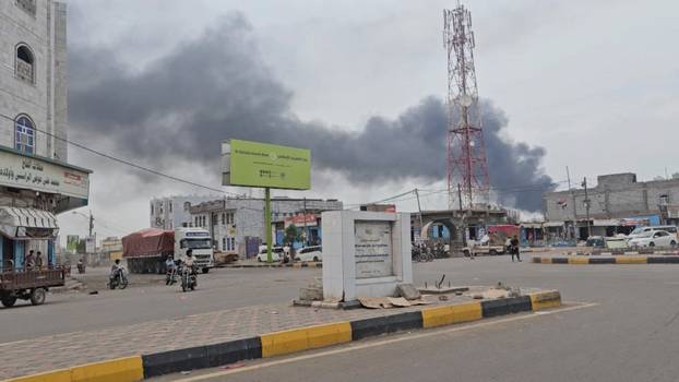 Smoke rises from the port following what the Yemeni military say was a Houthi attack on Mocha