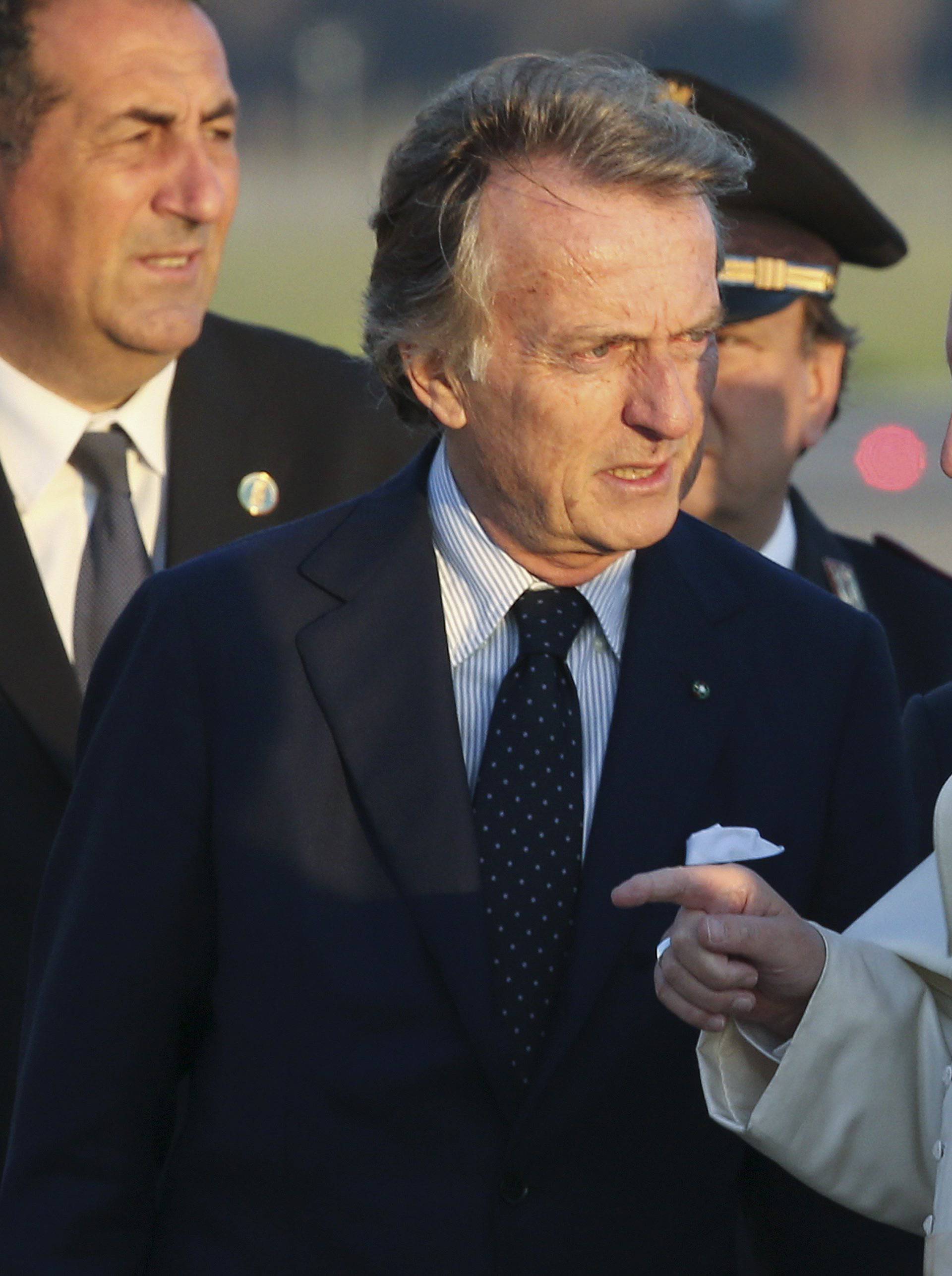 Pope Francis talks to Alitalia's President Luca Cordero di Montezemolo as he boards a plane at Fiumicino Airport in Rome