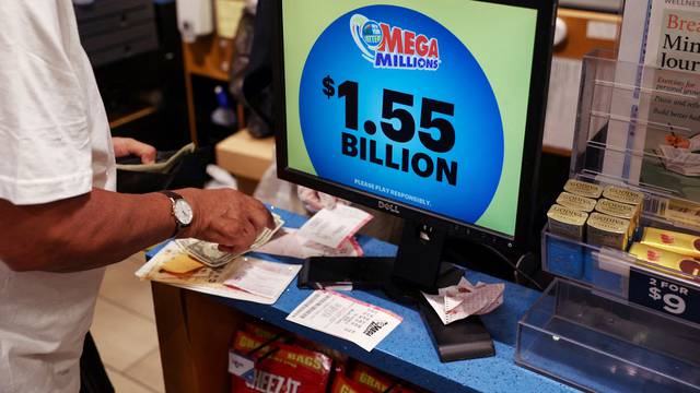 FILE PHOTO: The display in a store shows the Mega Millions lottery jackpot at $1.55-billion
