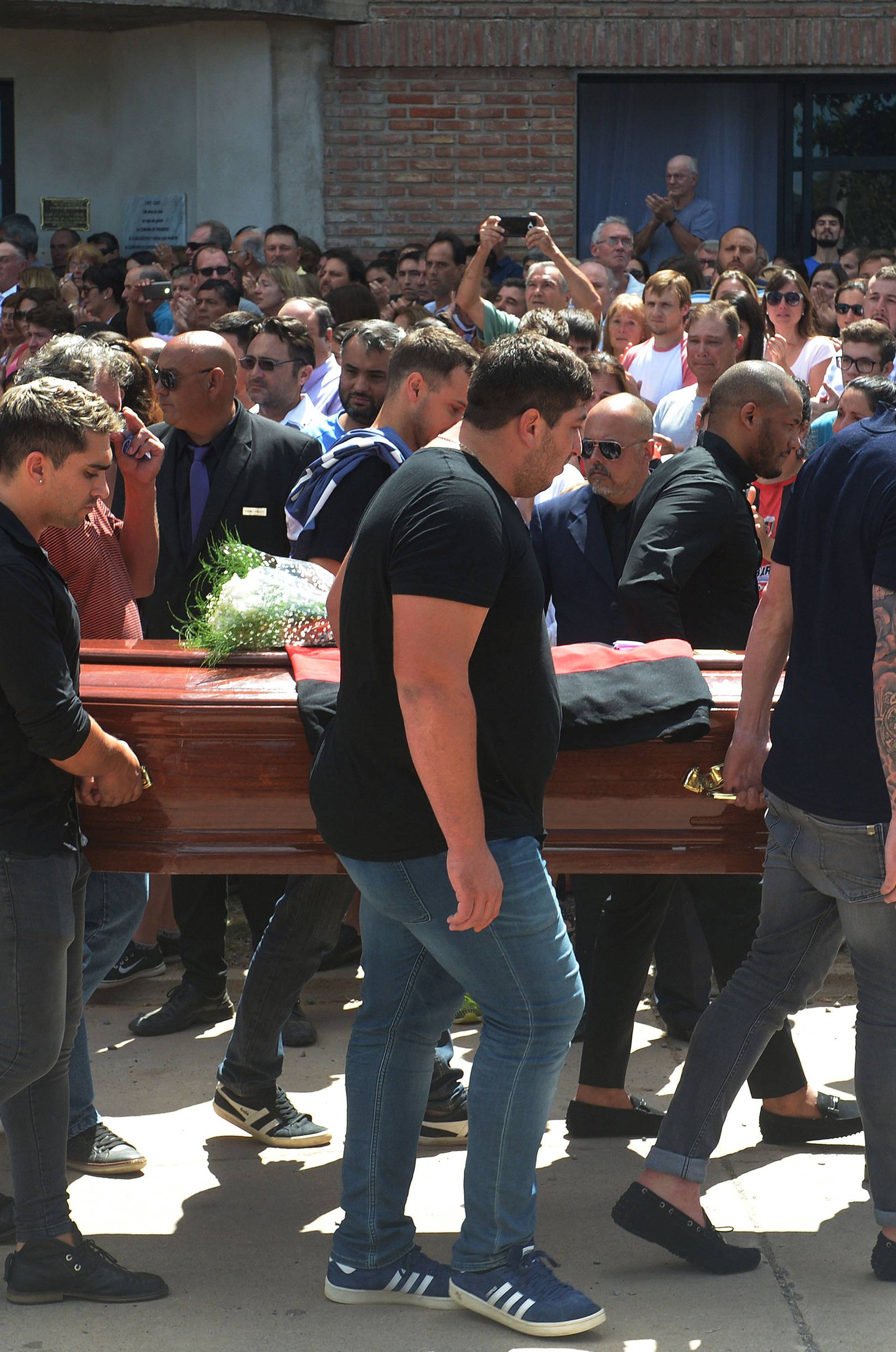 Family and friends carry the coffin of Emiliano Sala, soccer player who died in a plane crash in the English Channel, while a crowd attends his wake in Progreso
