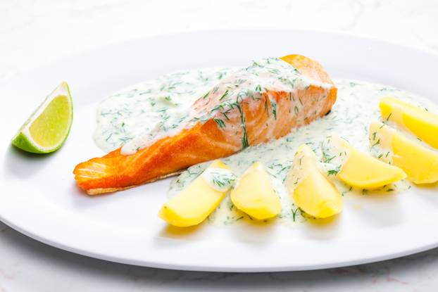baked salmon with creamy dill sauce and potatoes