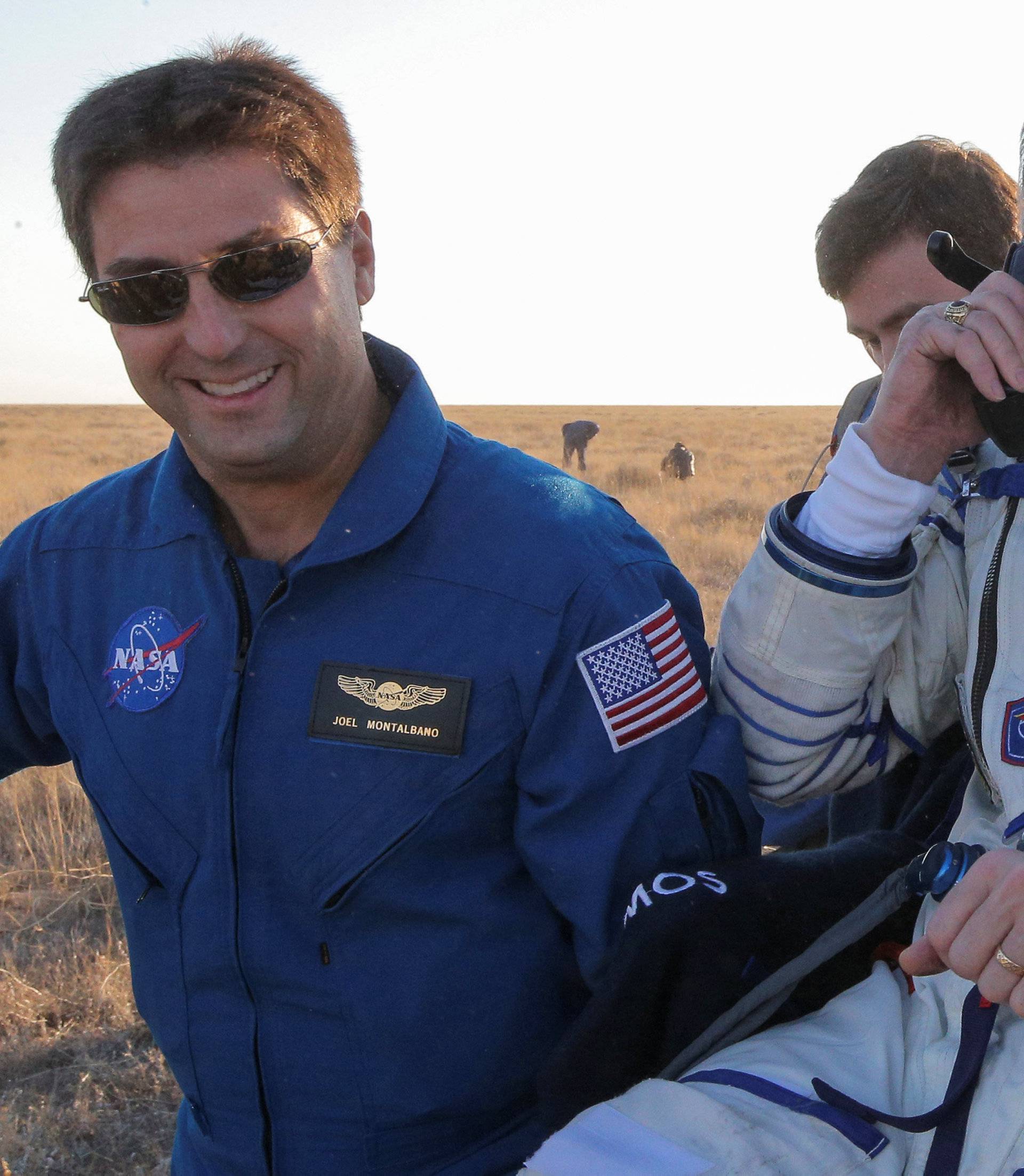 Ground personnel carry the International Space Station (ISS) crew member Jeff Williams of the U.S. after landing near the town of Zhezkazgan (Dzhezkazgan), Kazakhstan