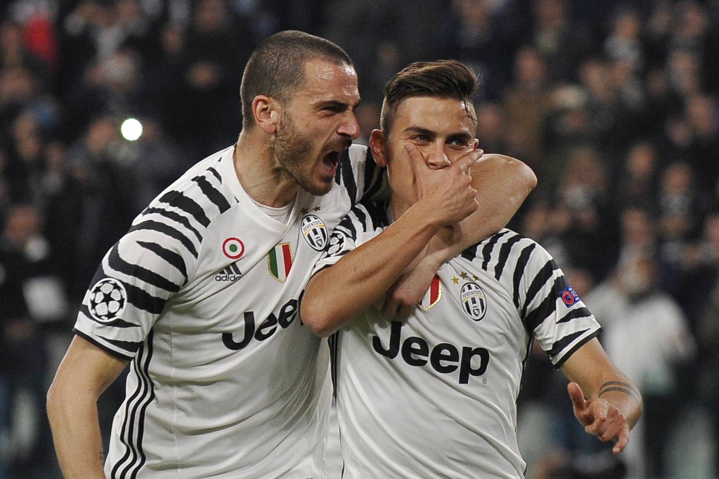 Juventus' Paulo Dybala celebrates scoring their first goal with Leonardo Bonucci