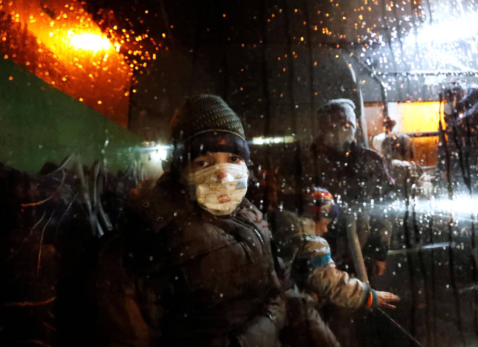 A child is seen inside a bus arranged to evacuate local residents, in Donetsk