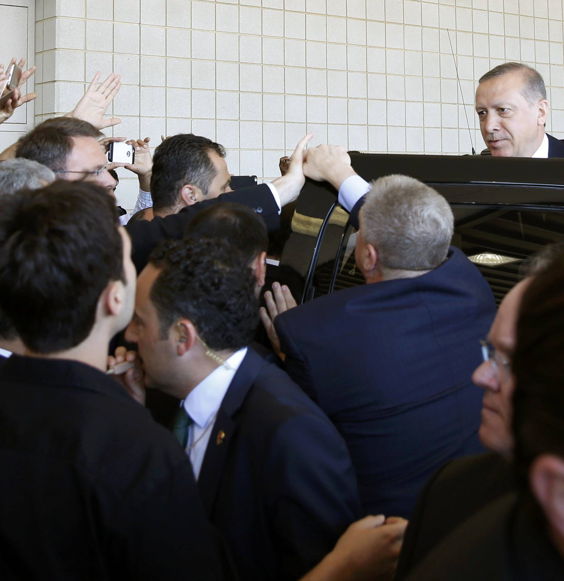 Turkish President Tayyip Erdogan (R) departs after attings the jenazah, an Islamic funeral prayer, for the late boxing champion Muhammad Ali in Louisville