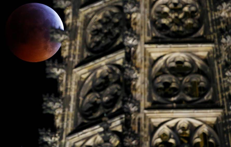 The "super blood wolf moon" is seen during a total lunar eclipse behind the gothic cathedral in Cologne
