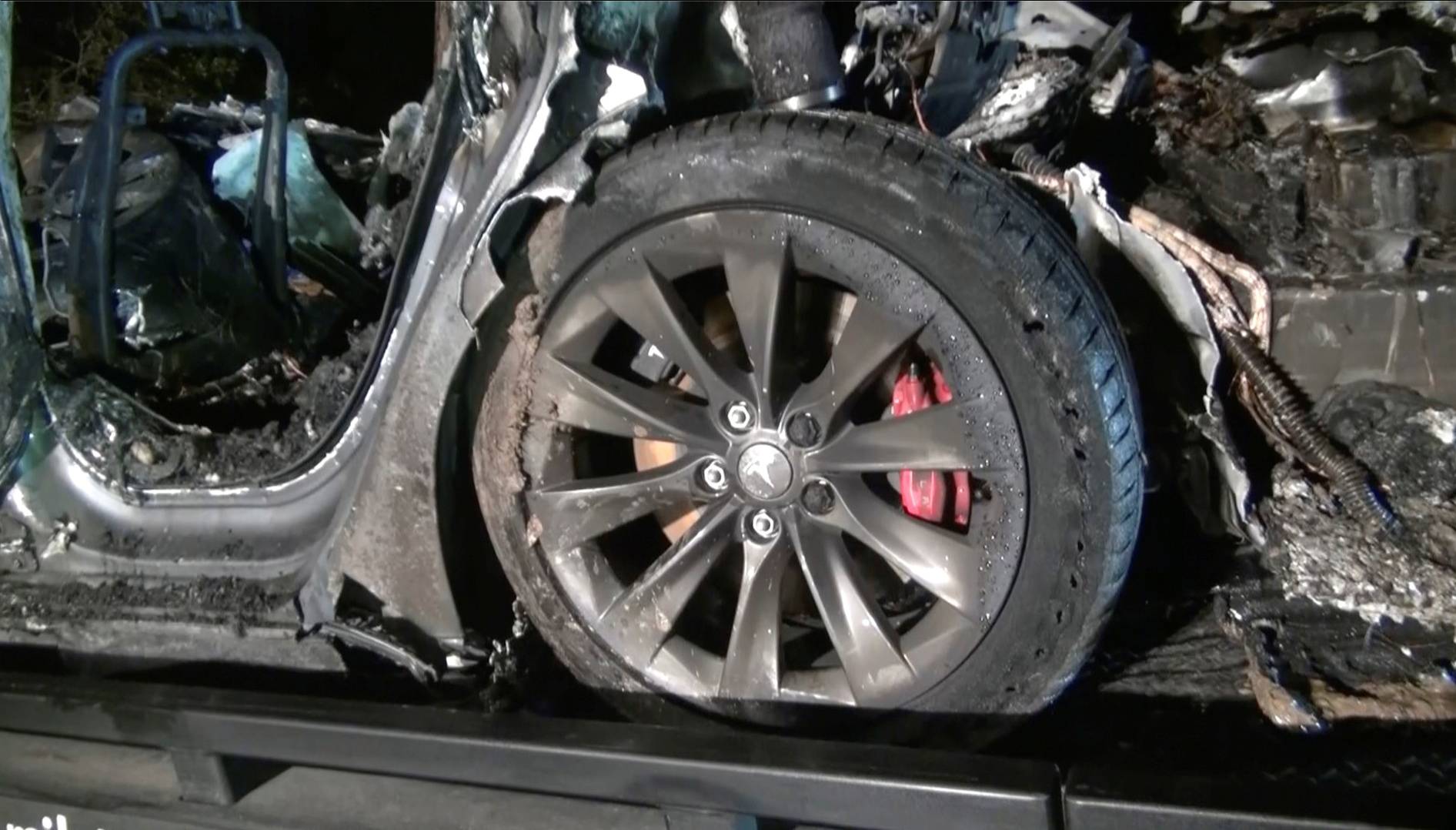 The remains of a Tesla vehicle are seen after it crashed in The Woodlands, Texas