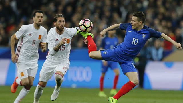 Spain's Sergio Ramos in action with France's Kevin Gameiro