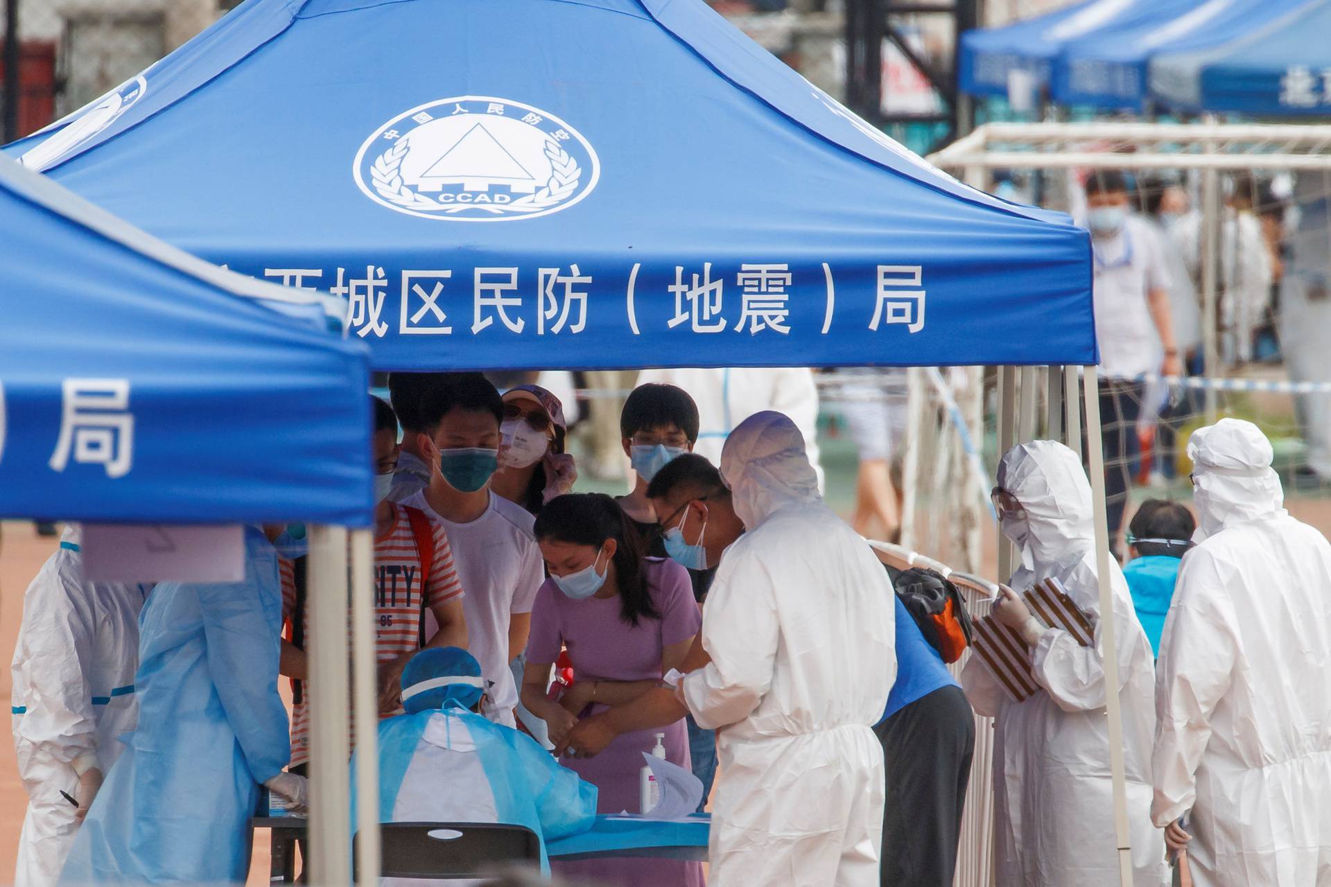 FILE PHOTO: People line up to get tested at the Guangan Sport Center after an unexpected spike of cases of the coronavirus disease (COVID-19) in Beijing
