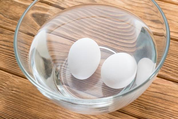 raw eggs in a bowl with water