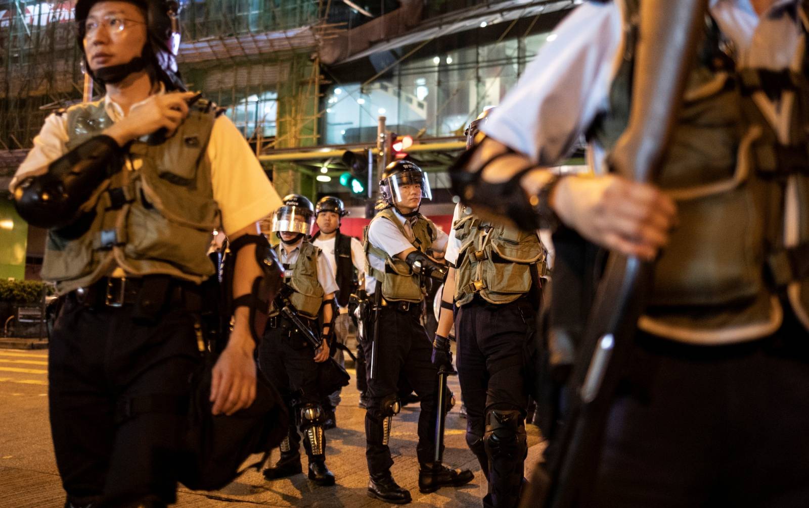 Police officers stand guard after breaking a protest near a police staion in Hong Kong