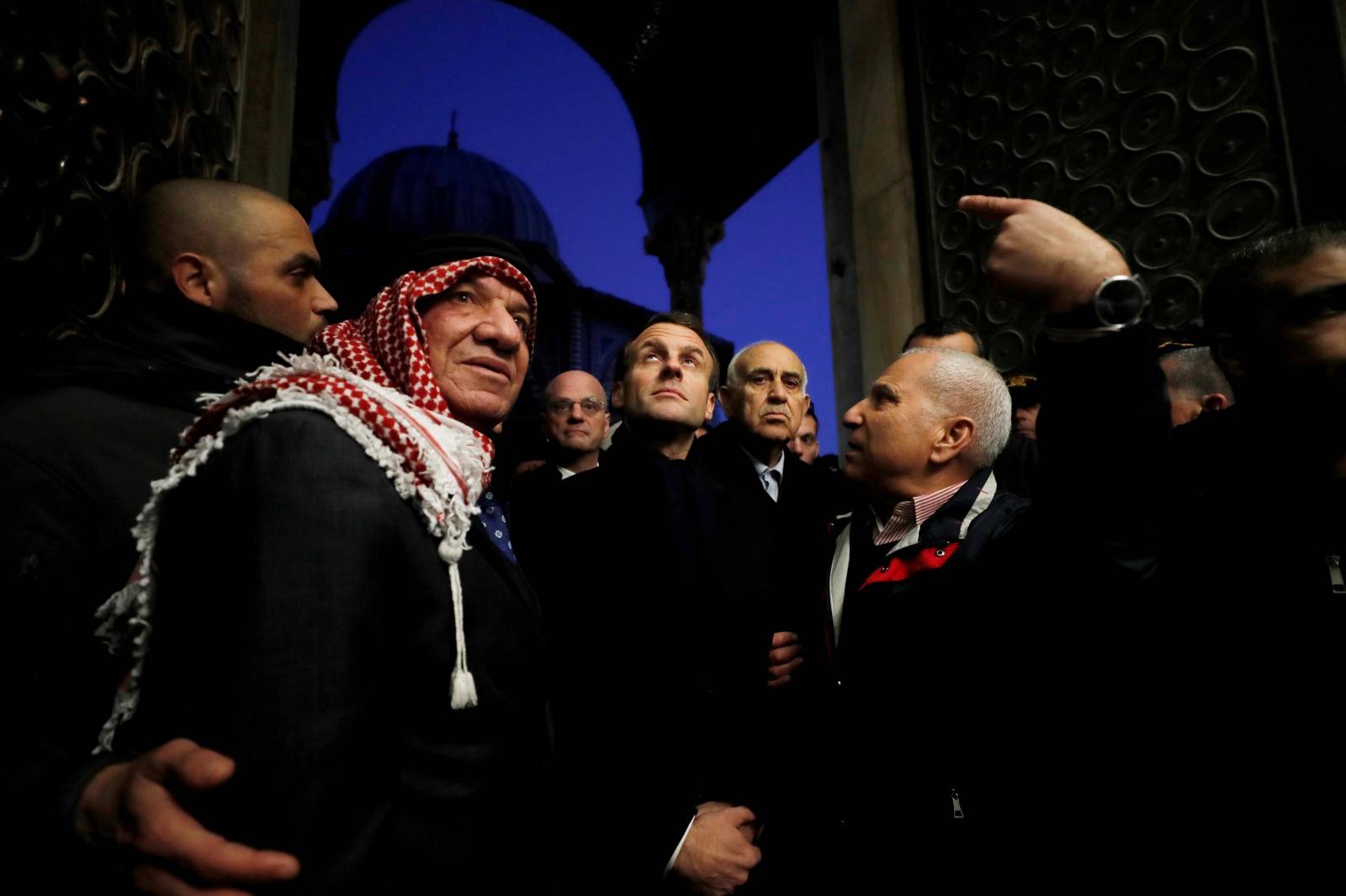 French President Emmanuel Macron looks up as he visits the compound housing al-Aqsa mosque known to Muslims as Noble Sanctuary and to Jews as Temple Mount, in Jerusalem's Old City