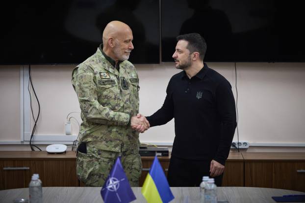 Kyiv, Ukraine. 08th Feb, 2025. Ukrainian President Volodymyr Zelenskyy, right, shakes hands with NATO Military Committee Chairman Adm. Giuseppe Cavo Dragone, left, before a tour of long-range drone production, February 8, 2025 in Kyiv, Ukraine. Credit: Uk