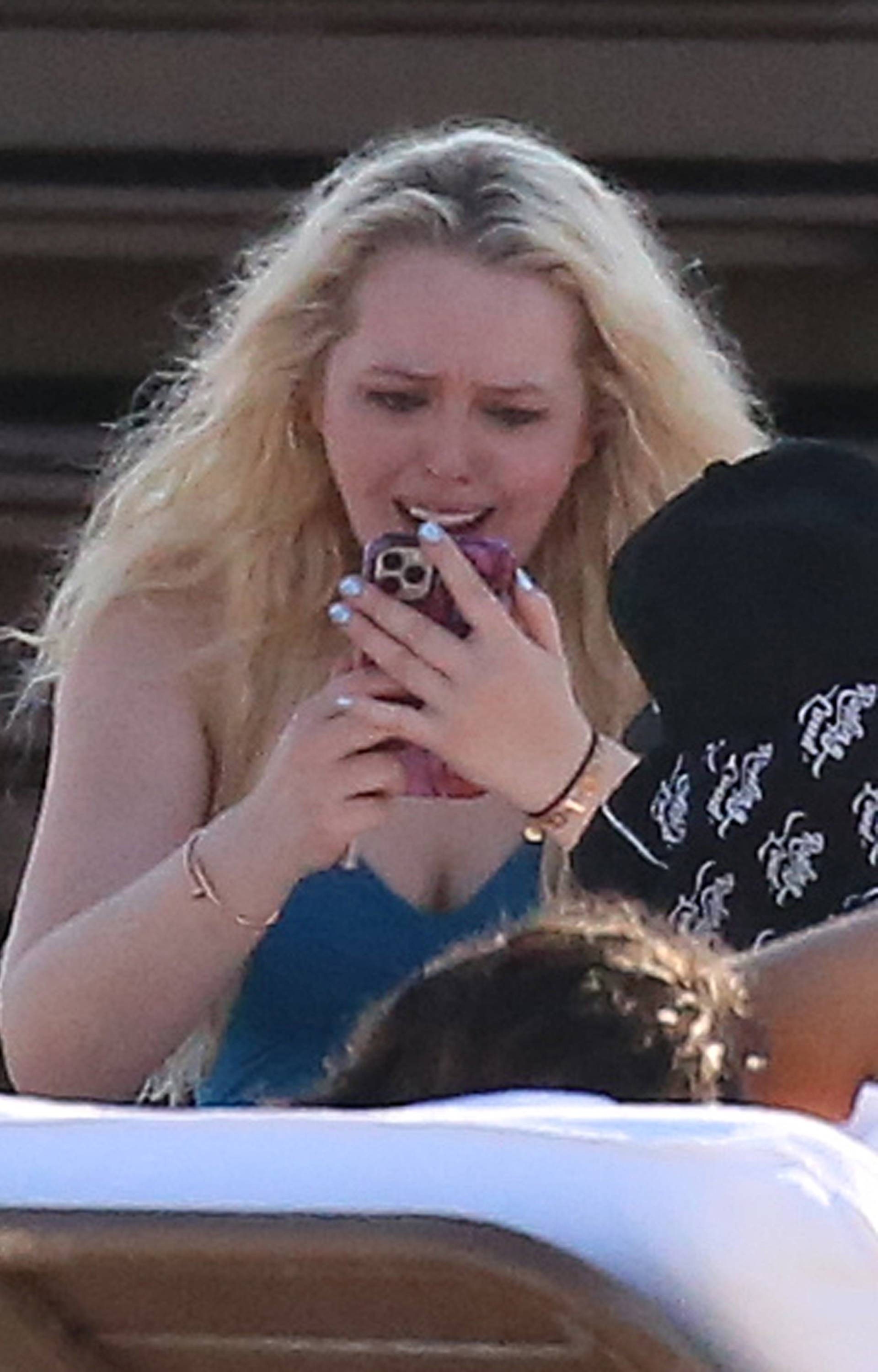 *NO WEB UNTIL 1500 EDT 15TH OCT PREMIUM EXCLUSIVE* Tiffany Trump wears a blue swimsuit and appears to go through a range of emotions as she relaxes on the beach with friends on her birthday in Miami