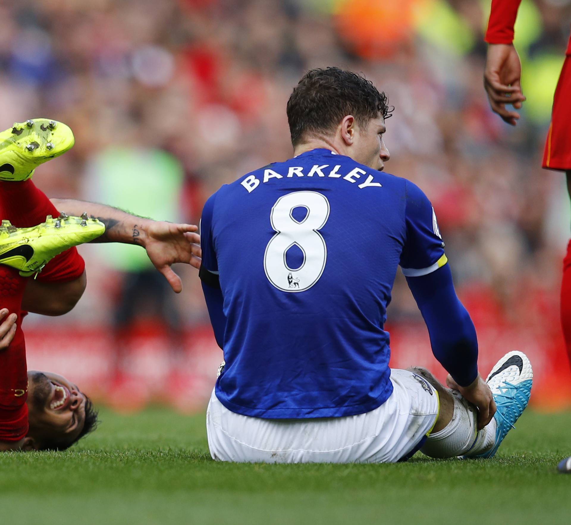 Everton's Ross Barkley fouls Liverpool's Dejan Lovren