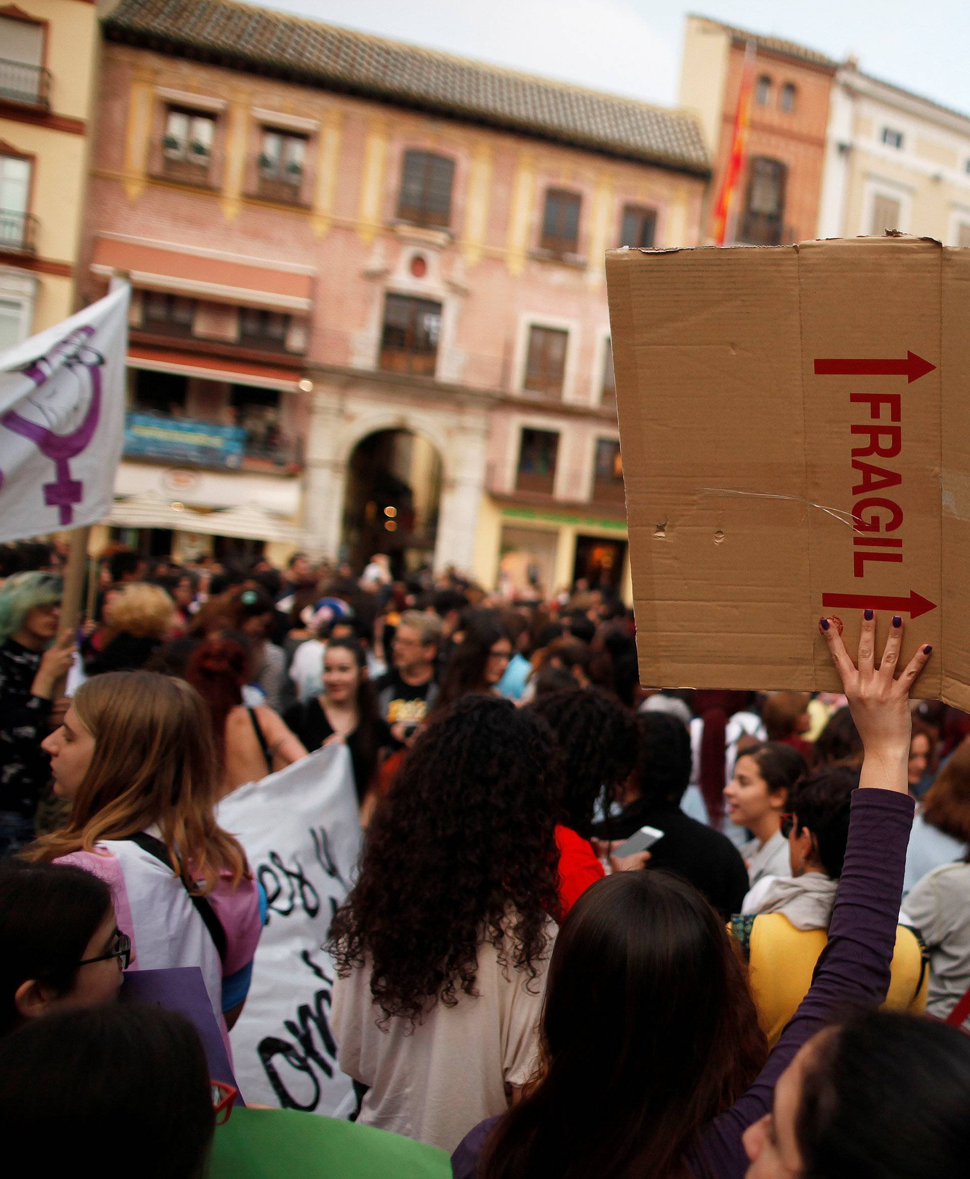 People take part in a protest after a Spanish court condemned five men accused of the group rape of an 18-year-old woman, in Malaga