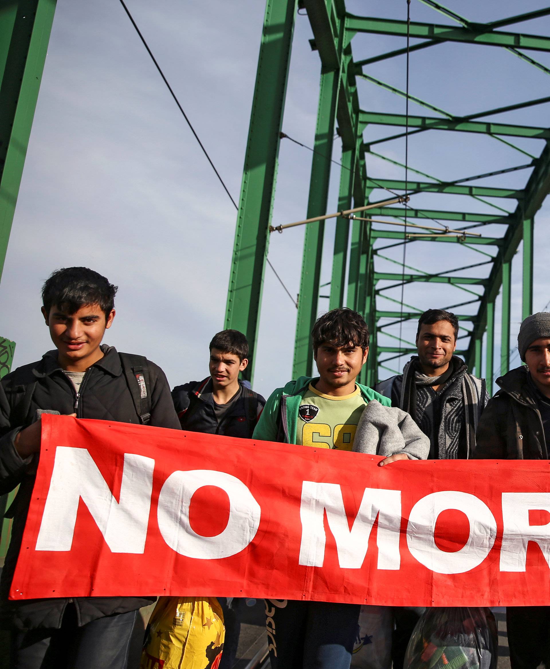 Refugees and migrants cross the Old Sava Bridge heading in the direction of the Croatian border, in Belgrade