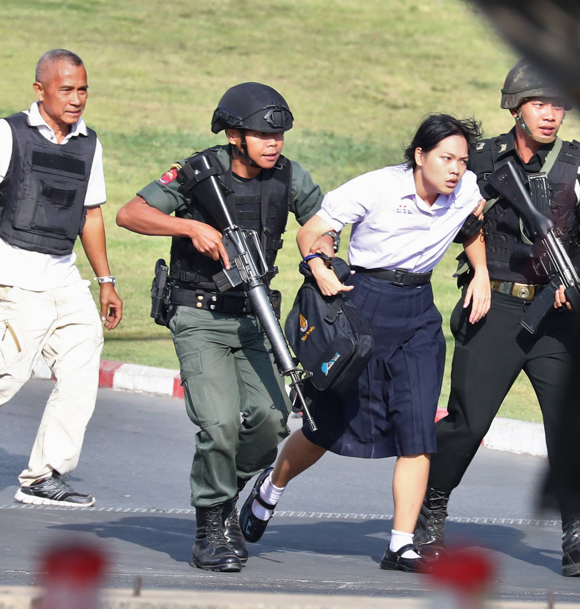 Thai security forces evacuate students stranded inside the Terminal 21 shopping mall following a gun battle to try to stop a soldier on a rampage after a mass shooting, Nakhon Ratchasima