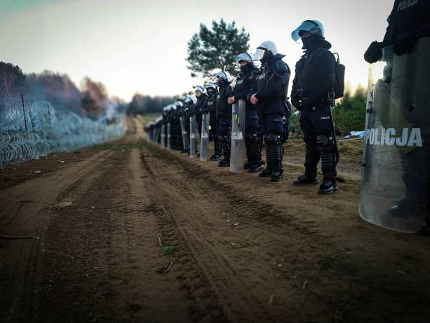 Polish police guard border fence on the Poland/Belarus border near Kuznica