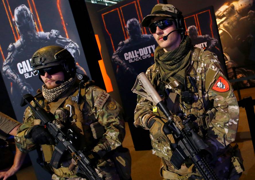 Men are dressed as soldiers to promote the video game "Call Of Duty Black Ops 3" at the Gamescom fair in Cologne