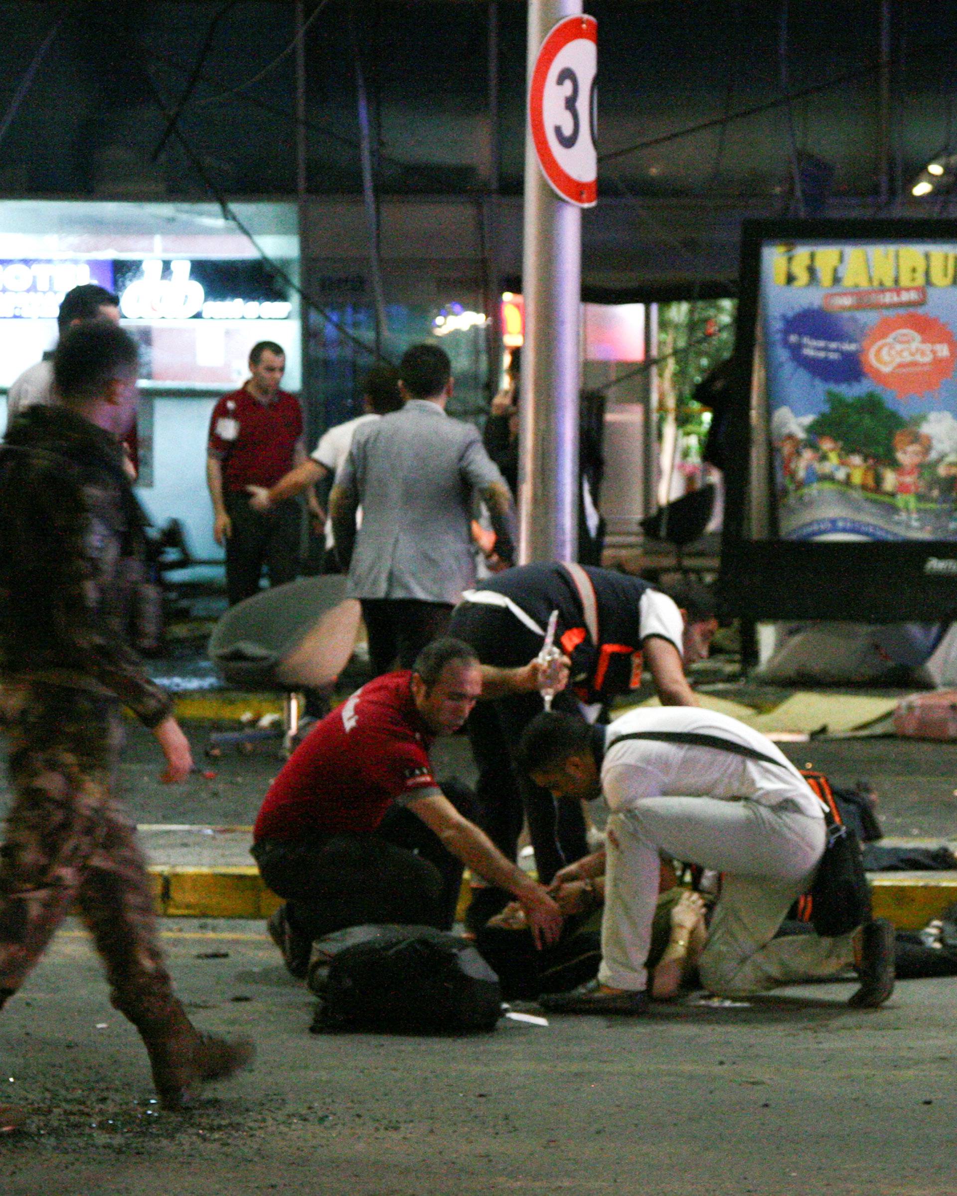 Paramedics attend to casualties injured outside Turkey's largest airport, Istanbul Ataturk, Turkey, following an attack