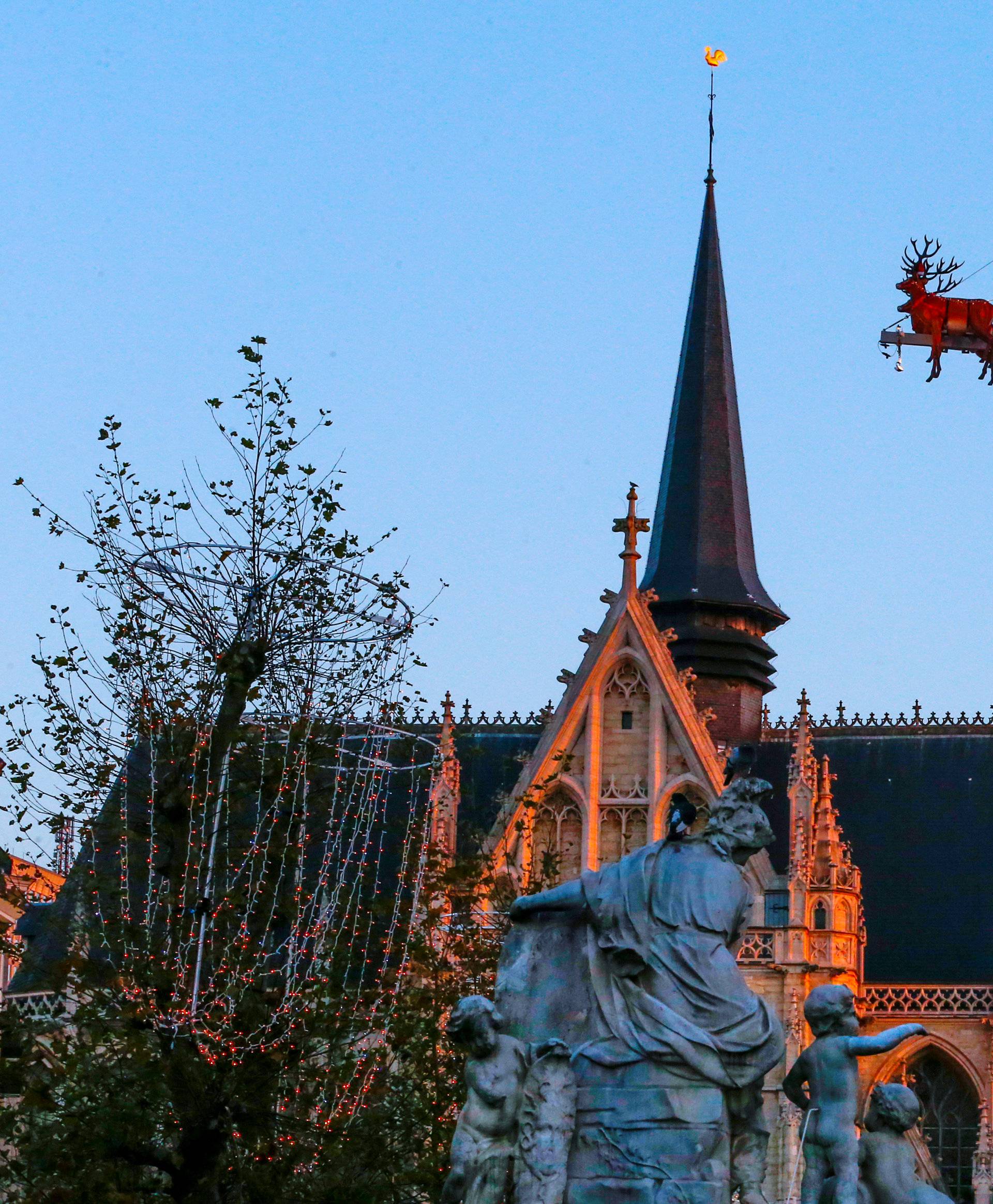 Guests enjoy dinner at the table "Santa in the sky", lifted by a crane and decorated to match the appearance of a "Santa Sleigh" as part as the Christmas festivities, in Brussels