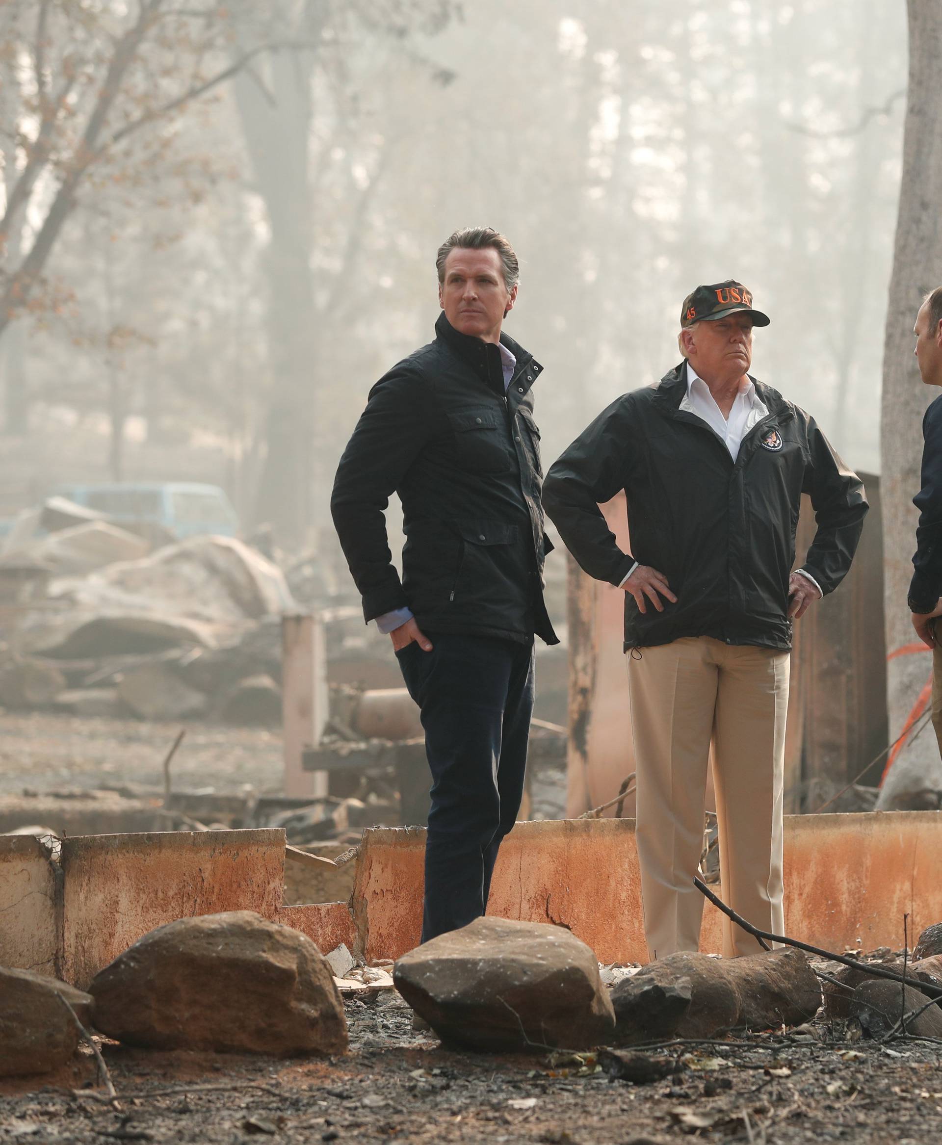 President Donald Trump visits the charred wreckage of Skyway Villa Mobile Home and RV Park with Governor-elect Gavin Newsom FEMA head Brock Long Paradise Mayor Jody Jones and Governor Jerry Brown in Paradise California