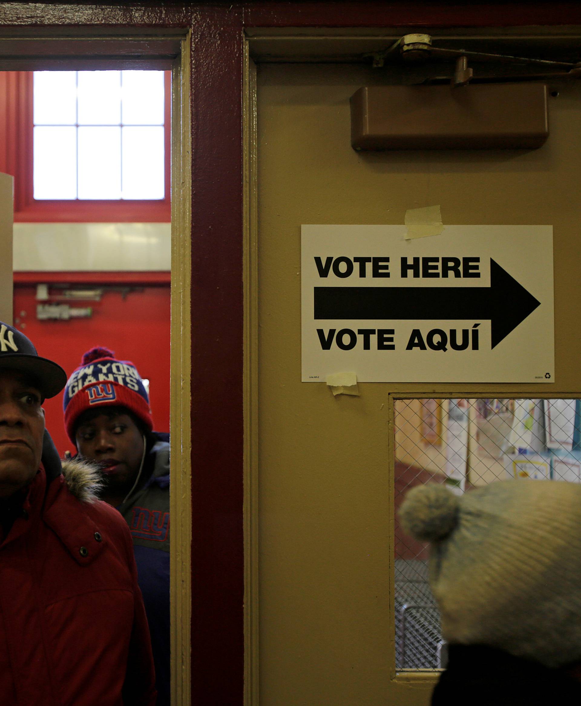 Voters arrive at a polling station to cast their votes during the U.S. presidential election at a polling station in the Bronx Borough of New York.