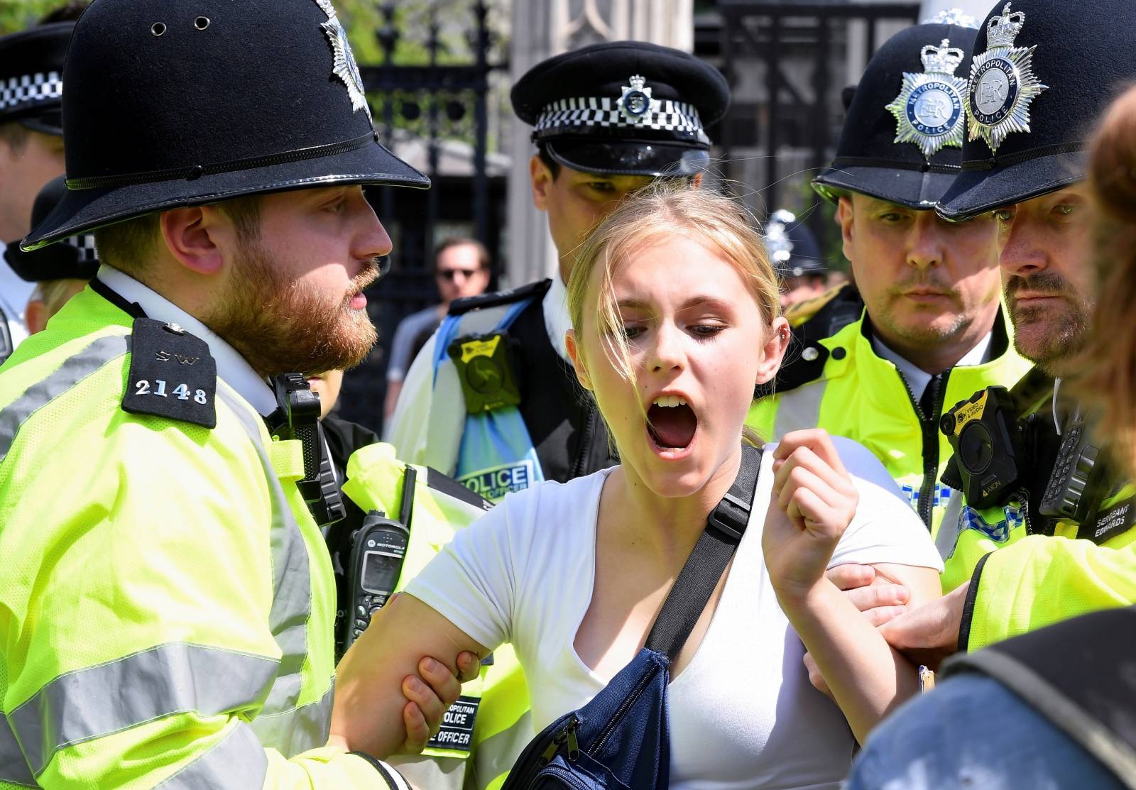 Police remove a climate change demonstrator during a march supported by Extinction Rebellion in London