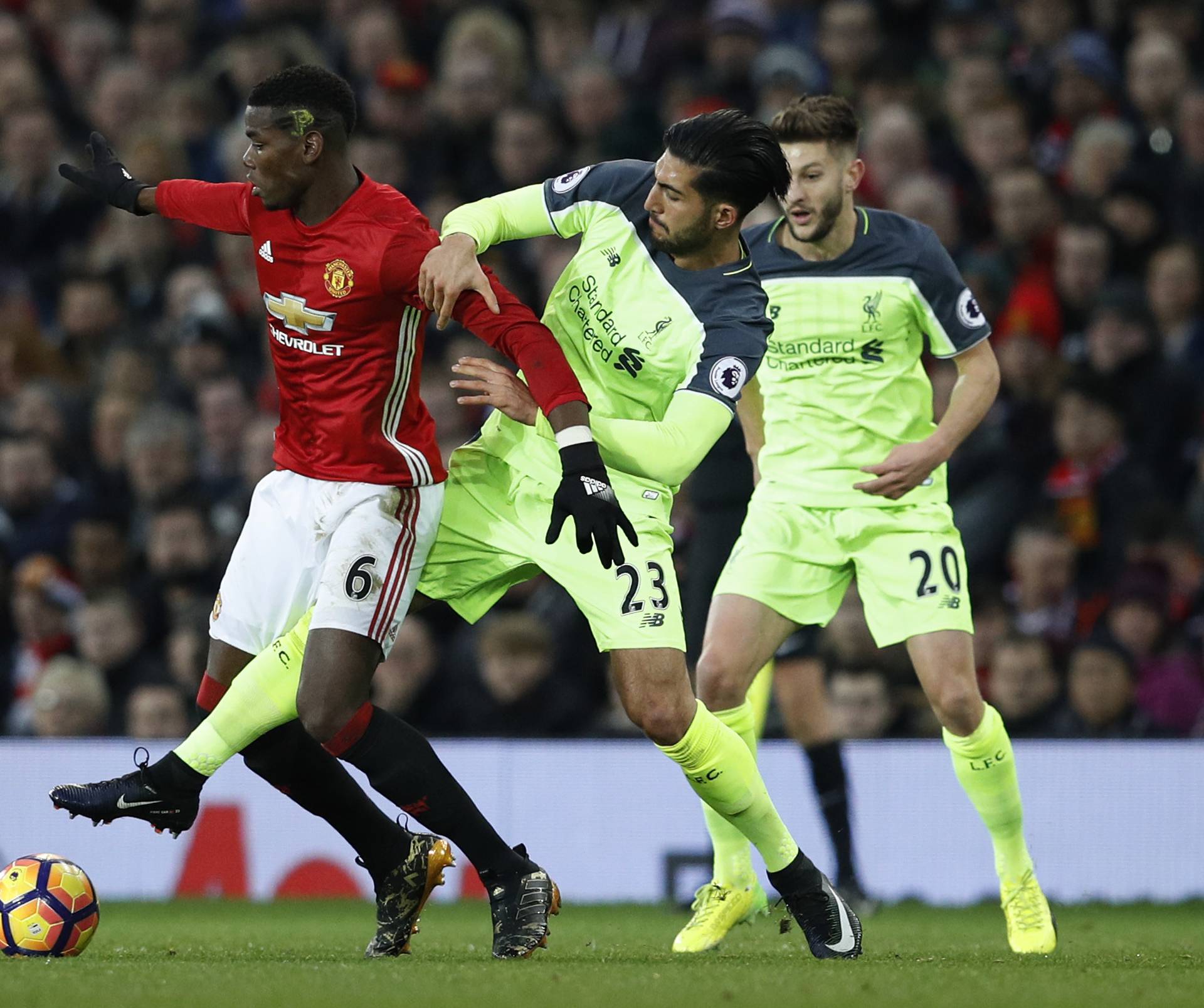 Manchester United's Paul Pogba in action with Liverpool's Emre Can and Adam Lallana