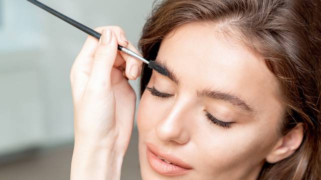 Woman with eyebrow brush tool