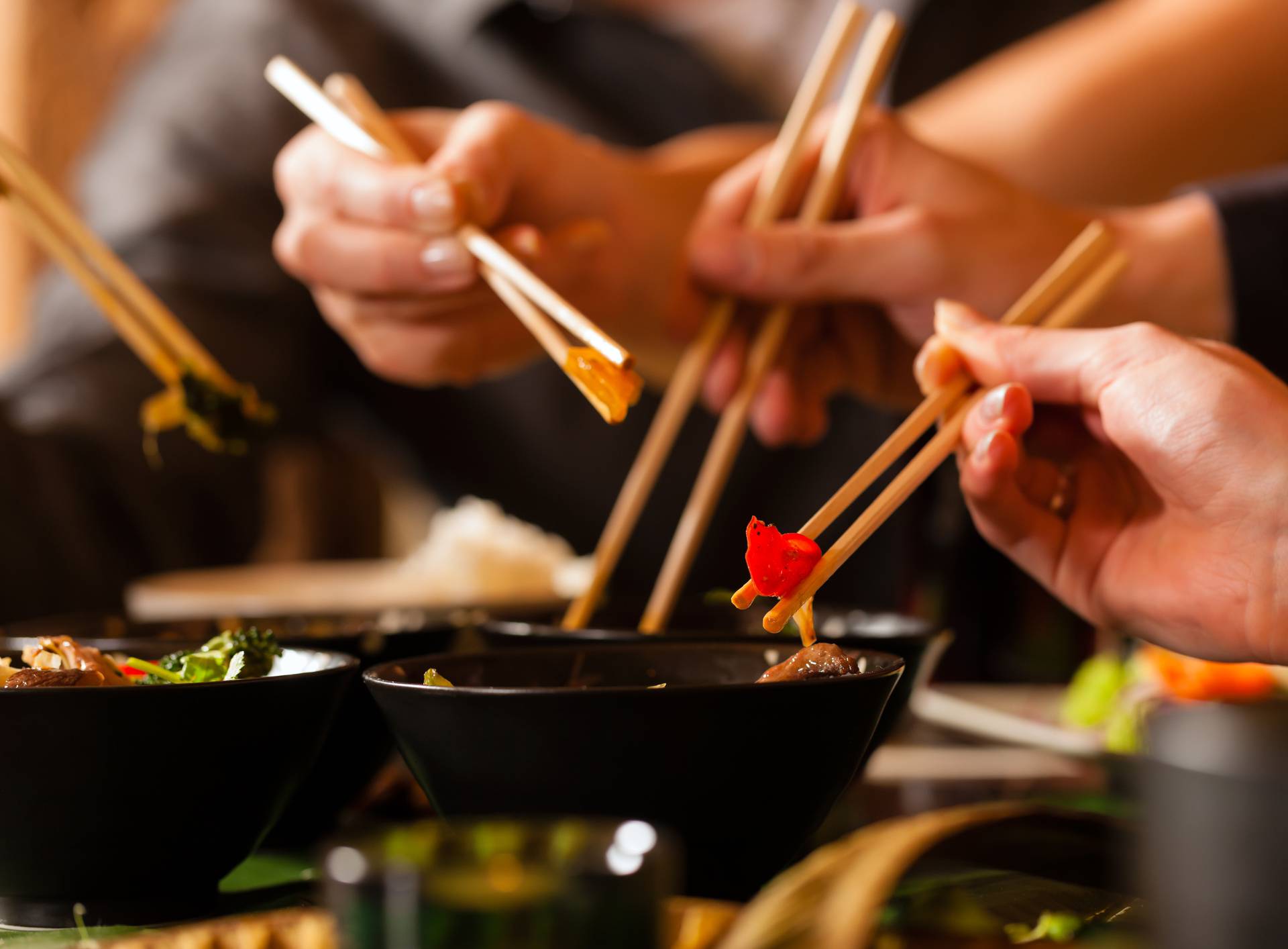 Young people eating in Thai restaurant