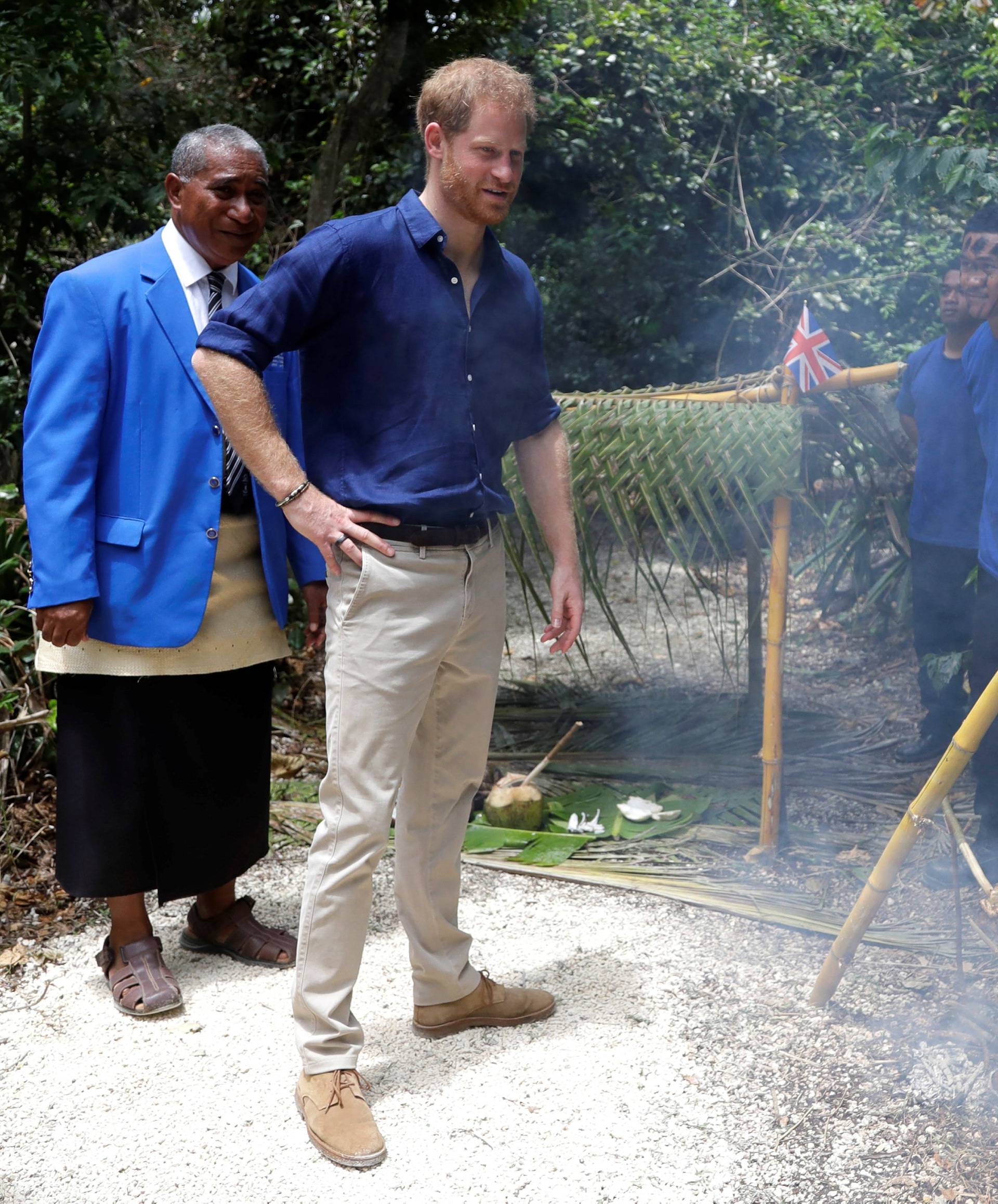 Britain's Prince Harry meets pupils as he walks through the forest during a visit to Tupou College in Tonga