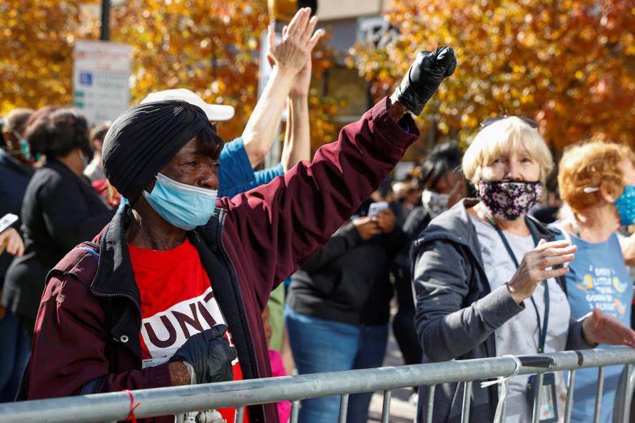 People react as media announce that Democratic U.S. presidential nominee Joe Biden has won the 2020 U.S. presidential election, in, Philadelphia