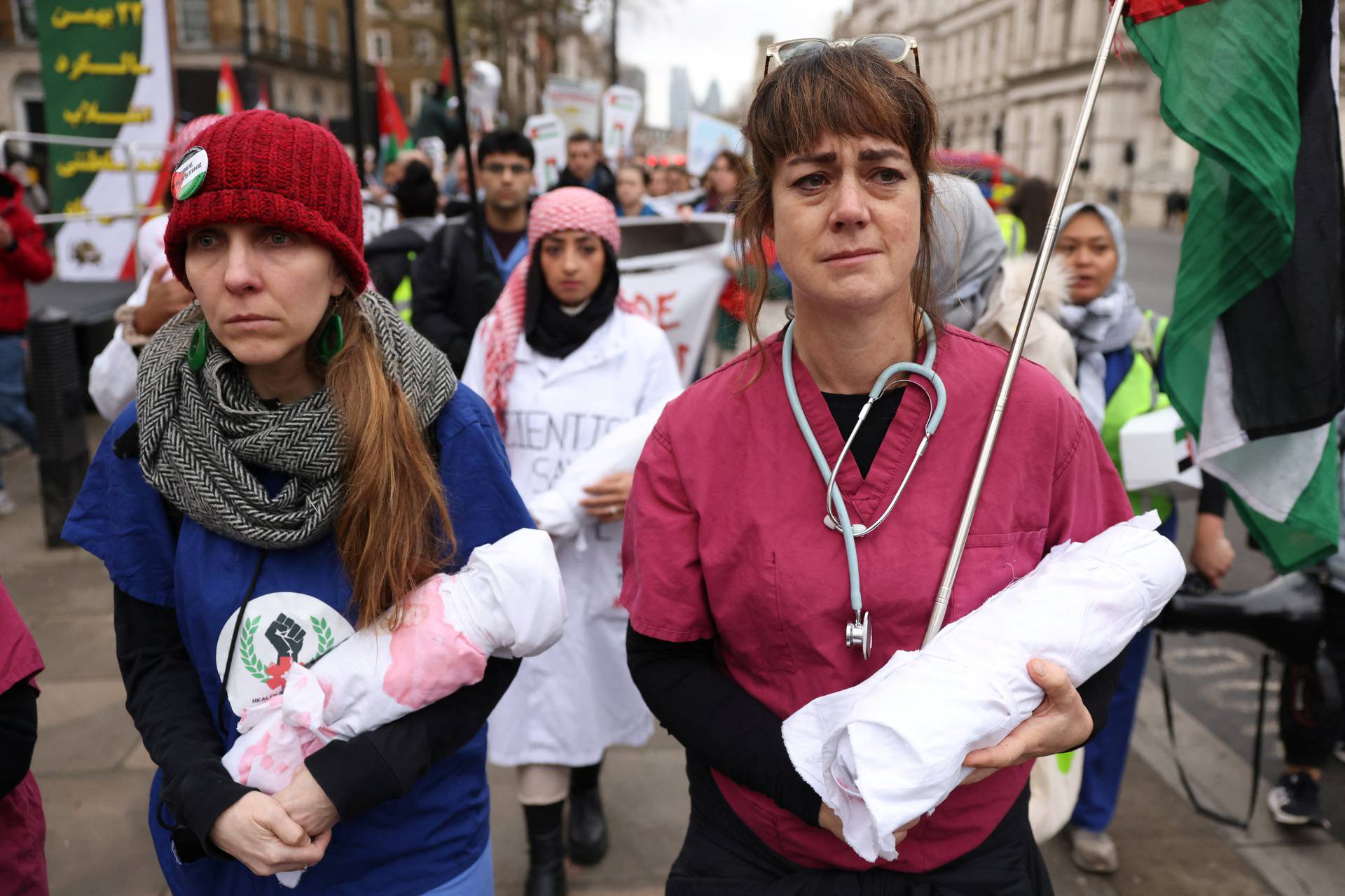 Health workers participate in a silent procession during a vigil for Gaza in London