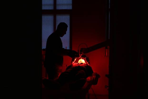 Former Ukrainian service member, who was wounded at a front line, comes to a clinic to treat scars, in Lviv