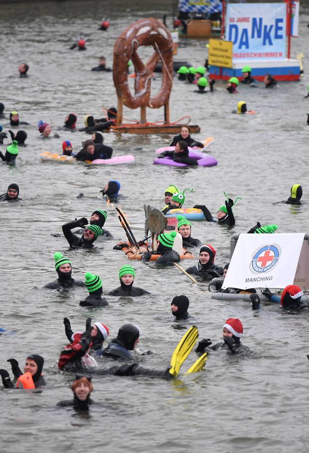 Swimmers wearing costumes bathe in the 3 degrees Celsius water of the river Danube in Neuburg an der Donau