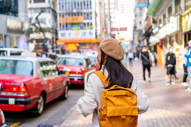 Young,Woman,Traveler,Walking,In,The,Mong,Kok,In,Hong