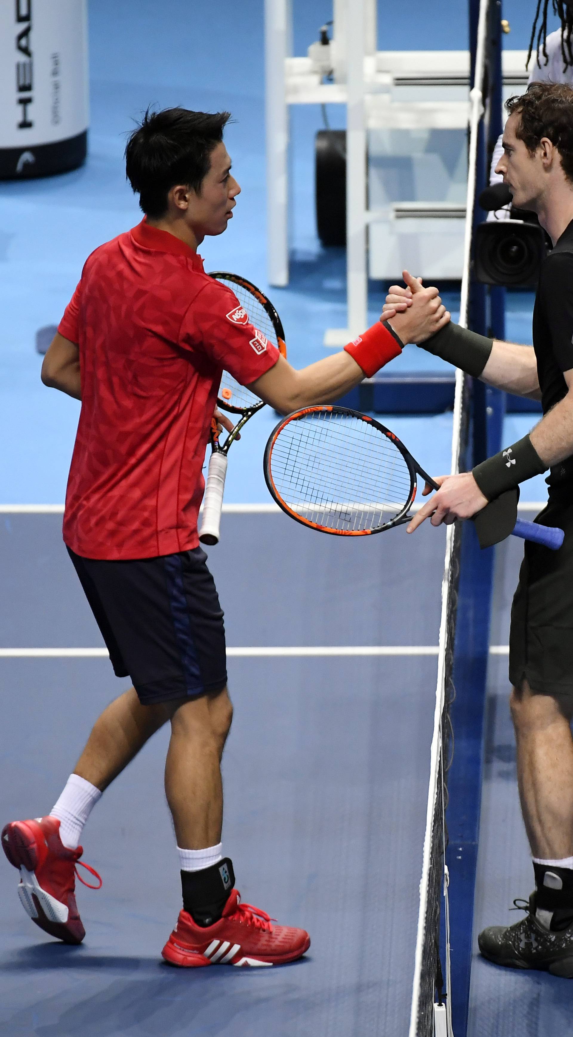 Great Britain's Andy Murray and Japan's Kei Nishikori shake hands after their round robin match