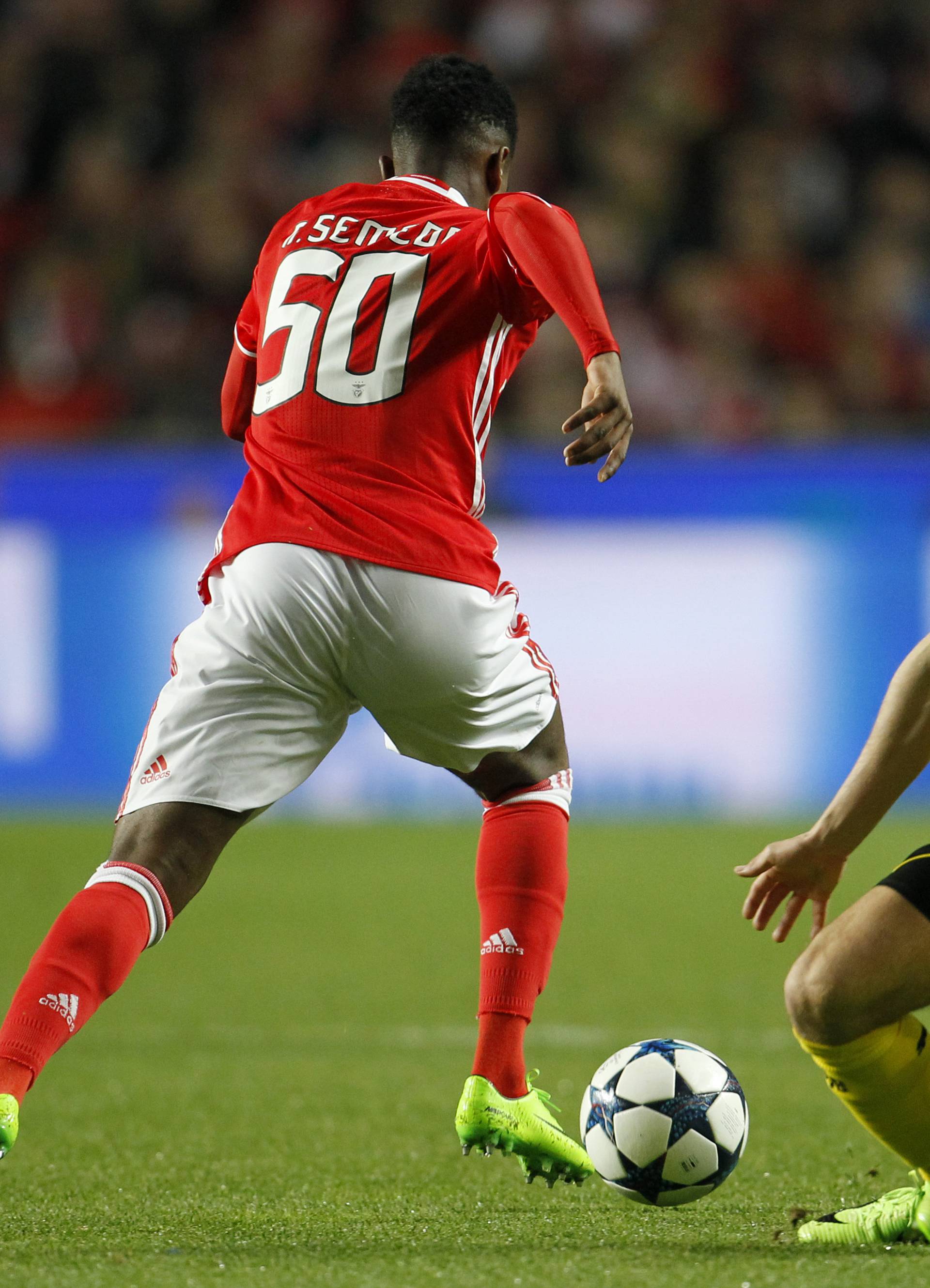 Benfica's Nelson Semedo in action with Borrusia Dortmund's Marcel Schmelzer