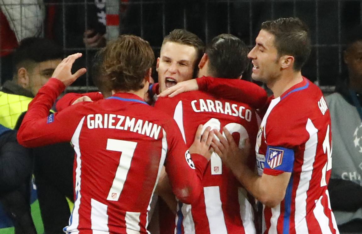 Atletico Madrid's Kevin Gameiro celebrates scoring their third goal from the penalty spot with Yannick Carrasco and Antoine Griezmann