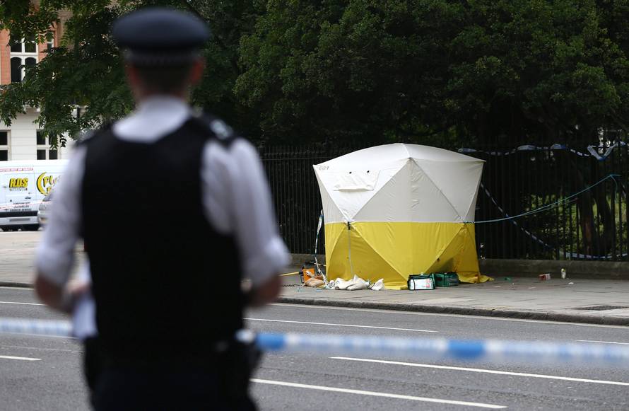 A police officer stands near a forensics tent after a knife attack in Russell Square in London