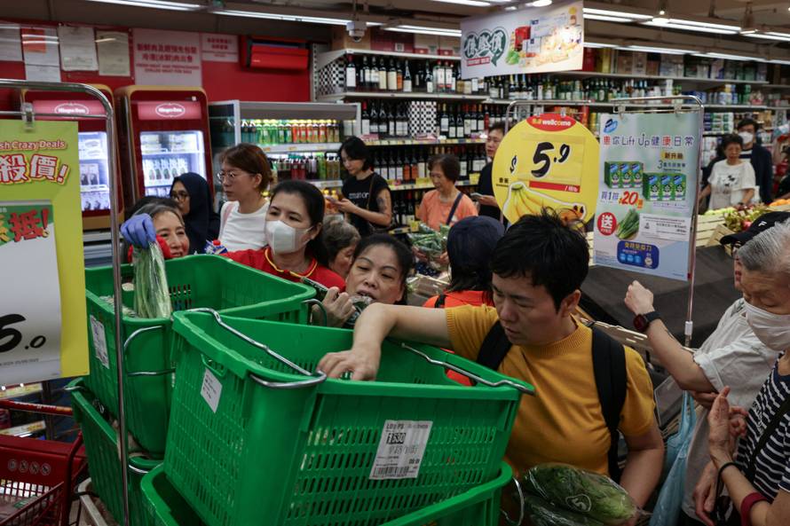 Residents stock up on supplies at a supermarket to prepare for the approaching Typhoon Ragasa, in Hong Kong